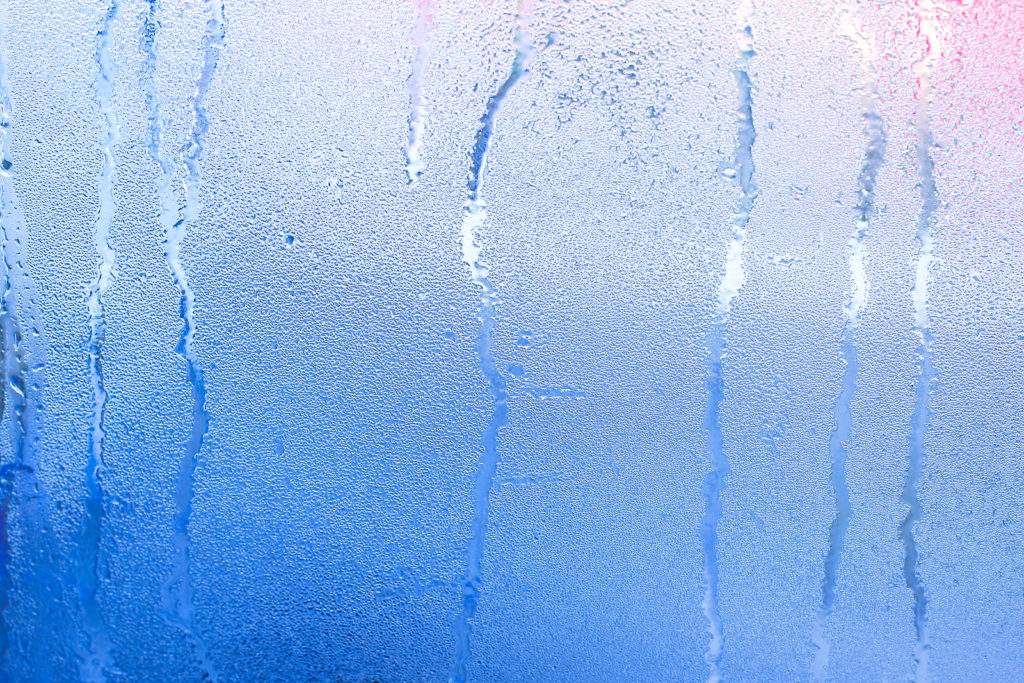 Autumn mood condensation on the glass temperature drop. Window Glass With Condensation Strong High Humidity Large Water Droplets Flow Down the Window Natural Water Drops on Window Glass
